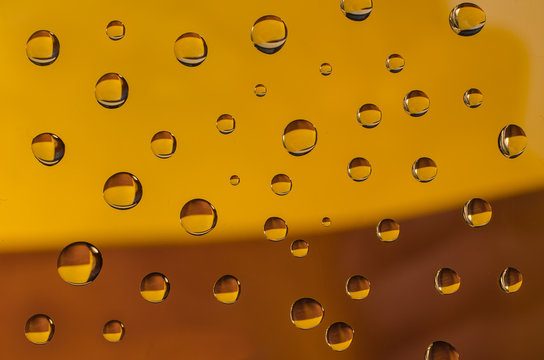 Drops Of Water On Yellow Brown  Background