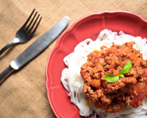 Italian spaghetti on red plate