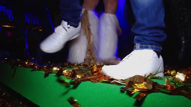 Beautiful dancing feet on gladness revelry party. Cheerful and energetic art music fun dancing in motion feet legs of group people human men and women female in a disco in shoes of different colors. 