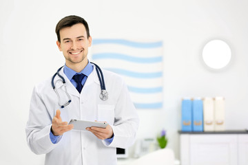 Doctor with tablet in office