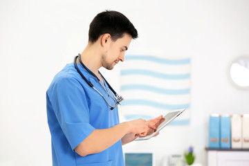 Doctor with tablet in office