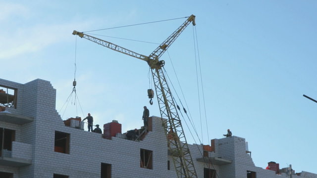 Construction of apartment houses. Crane, workers