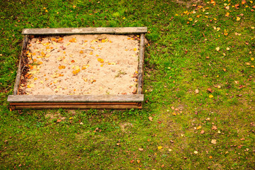Empty sandbox sandpit in autumn fall.