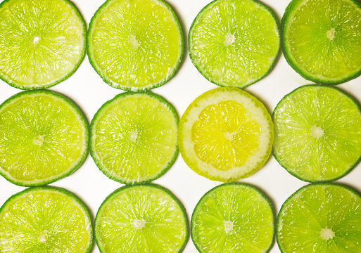 Group of Green Lime Slices with One Standout Lemon Slice
