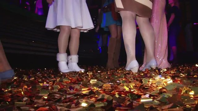 Beautiful dancing feet on gladness revelry party. Cheerful and energetic art music fun dancing in motion feet legs of group people human men and women female in a disco in shoes of different colors. 