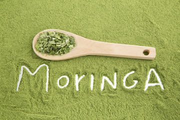 Moringa powder with wooden spoon