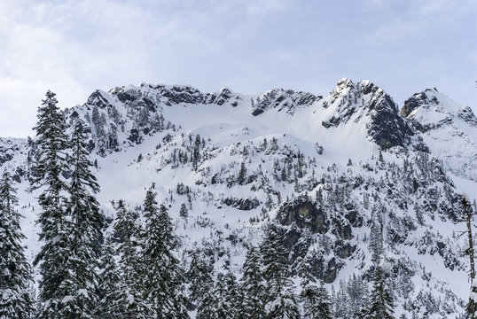 Snow Covered Mountain Ridge with Rocky Cliffs