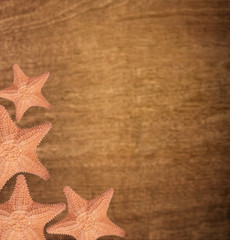 Fototapeta na wymiar Starfishes on wooden background
