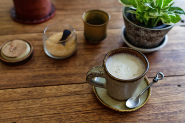 Cup of tea on a wooden table, a flower ы a pot on a table, tasty tea, fragrant tea, kiromichesky natural ware