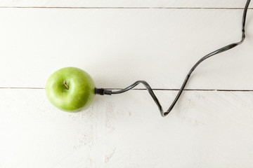 The picture shows an apple connected to an ethernet cable conceptualizing the internet of things...