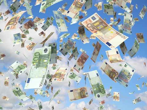euro banknotes falling on blue sky in the background