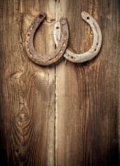 Two Rusty Horseshoes Hangs On Old Wooden Barn Wall. Lucky Concept