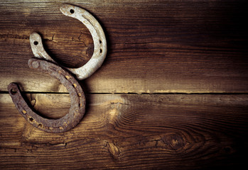 Two Lucky Horseshoes On Old Wooden Floor Of Barn In Vintage Style. Lucky Concept.
