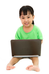 Chinese little girl sitting on floor with laptop