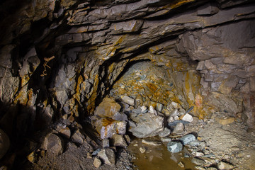 Underground gold mine ore tuneel with stones rockfall Berezovsky mine Ural