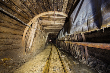 Fototapeta na wymiar Underground gold mine tunnel with rails Berezovsky mine Ural