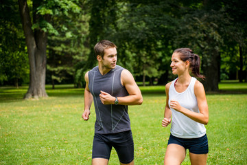 Training together - young couple jogging