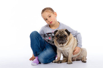 The girl cares for the dog, listens to a stethoscope.