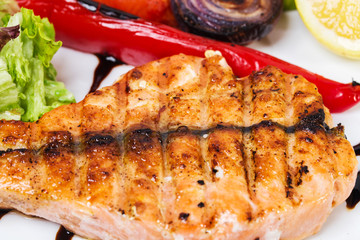 Grilled salmon fillet with roasted vegetables.