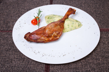 Duck leg confit with potato puree.