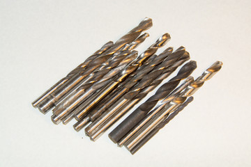 The group of drill bits different diameters on white background