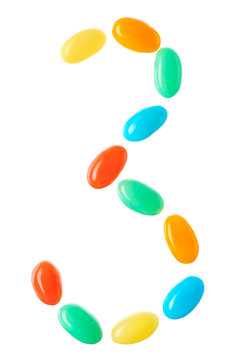 3 number made of multicolored candies isolated on white