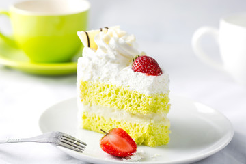 Close up Japanese Matcha Green tea cake decorated with strawberr