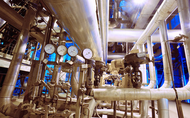 Equipment, cables and piping as found inside of a modern industr