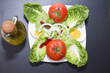 salad plate and bottle of oil on board