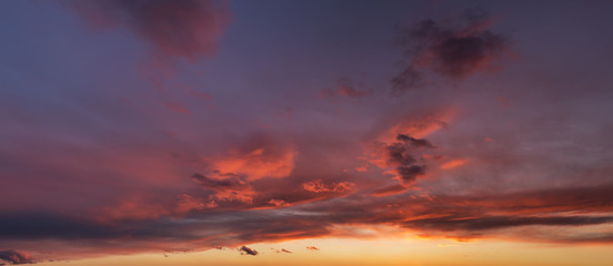Naklejka na ściany i meble Beautiful sunset sky with dark-red clouds. Hi-res panorama.