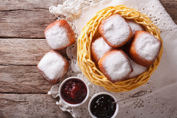 Sweet beignets with powdered sugar and jam. Horizontal top view
 - obrazy, fototapety, plakaty