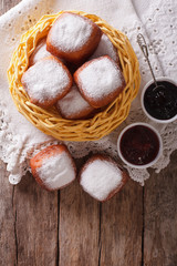 Sweet beignets with powdered sugar and jam. vertical top view

