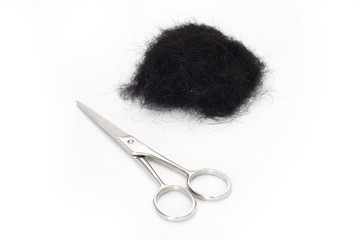 Scissors and scraps of black hair.