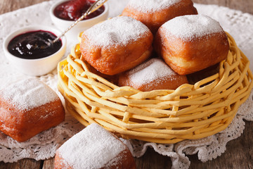 fried square beignets in the basket close up on the table. horizontal
