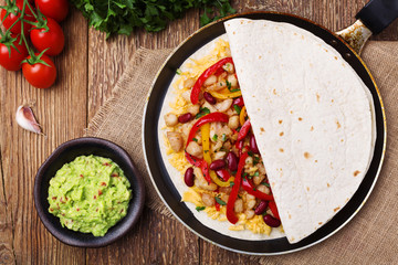 Quesadilla with chicken, served with guacamole or salsa sauce.