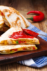 Quesadilla with chicken, served with guacamole or salsa sauce.