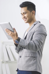 asian man using tablet pc