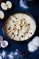 Raw apple pie on a blue background