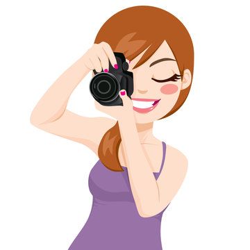 Beautiful happy smiling photographer woman taking photos using digital reflex camera