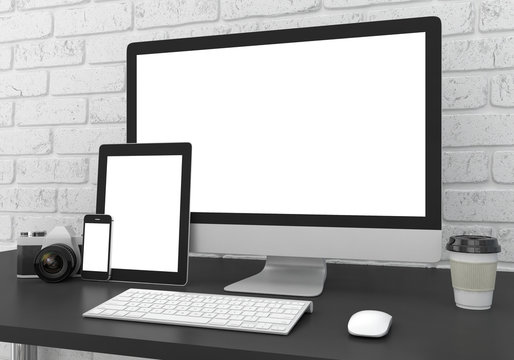 Responsive mockup screen. Monitor, tablet, phone on table in office.