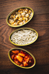 Canned food appetizer, top view on a wooden table.