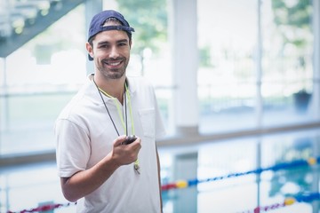 Serious trainer looking at stopwatch