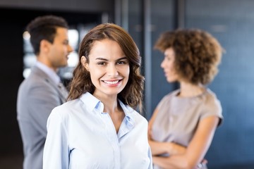 Confident businesswoman looking at camera in office