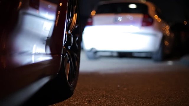 Shot of a wheel while driving a sports car at night.