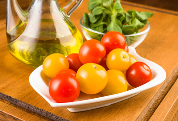 Whole cherry tomatoes in porcelain tray