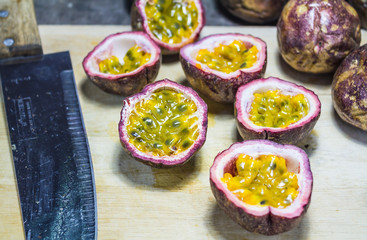 Passion fruit on chopping block with knife
