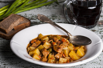 Portion of traditional irish beef, guinness beer stew with carrots and potato