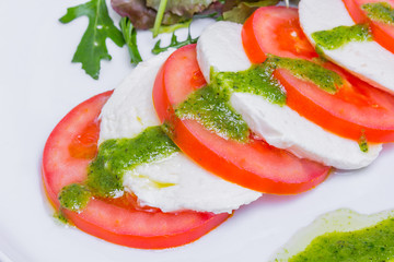 Fresh salad with tomatoes, mozzarella, closeup