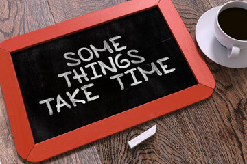 Some Things Take Time Handwritten by White Chalk on a Blackboard. Composition with Small Red Chalkboard and Cup of Coffee. Top View. 3D Render.