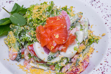 Salmon salad with prawns, closeup